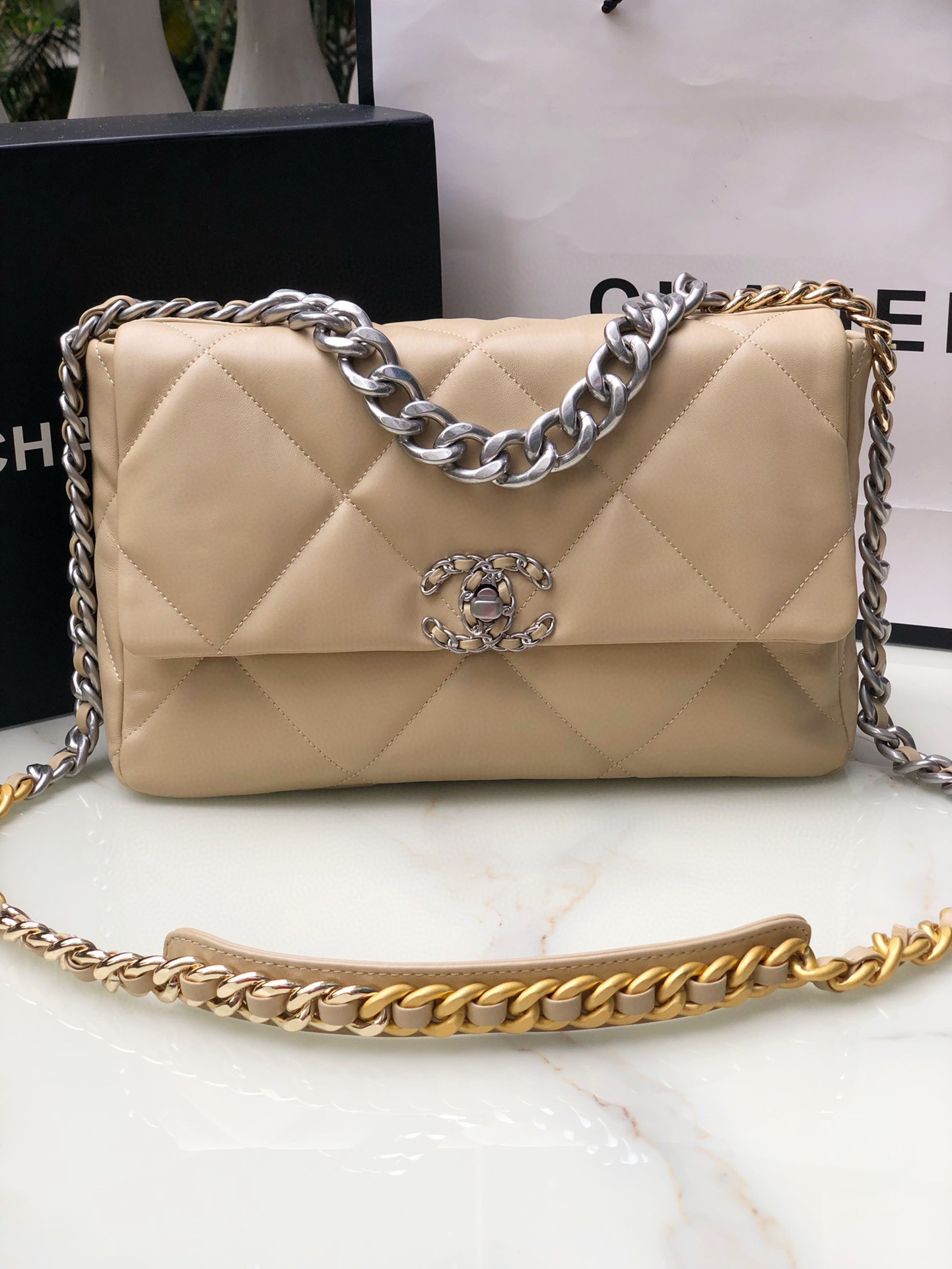 Ch*el 19 handbag shiny leather, gold-tone, silver-tone & ruthenium-finish metal beige 30x20x10cm