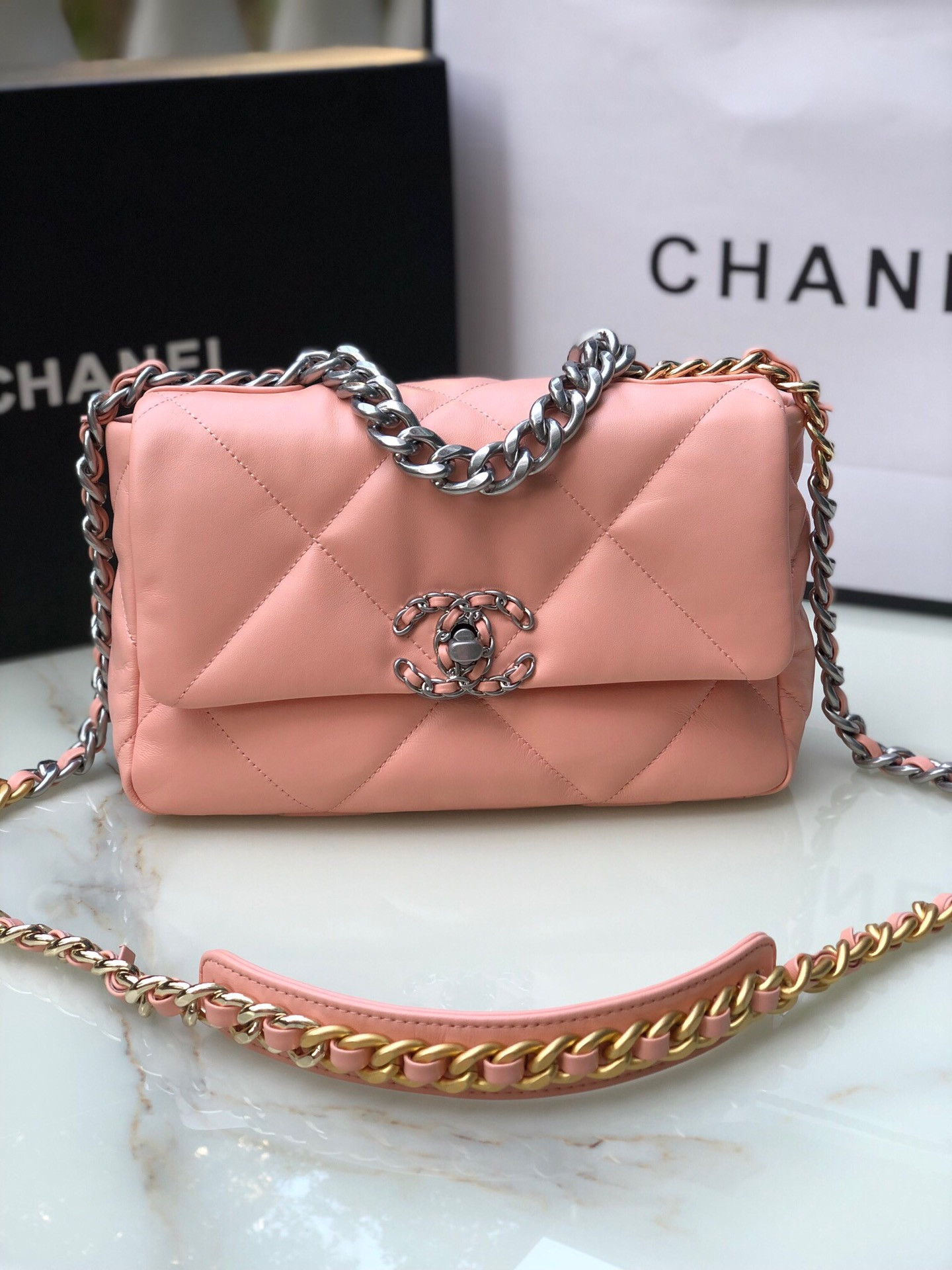Ch*el 19 handbag shiny leather, gold-tone, silver-tone & ruthenium-finish metal light pink 6.2 × 10.1 × 3.5 in