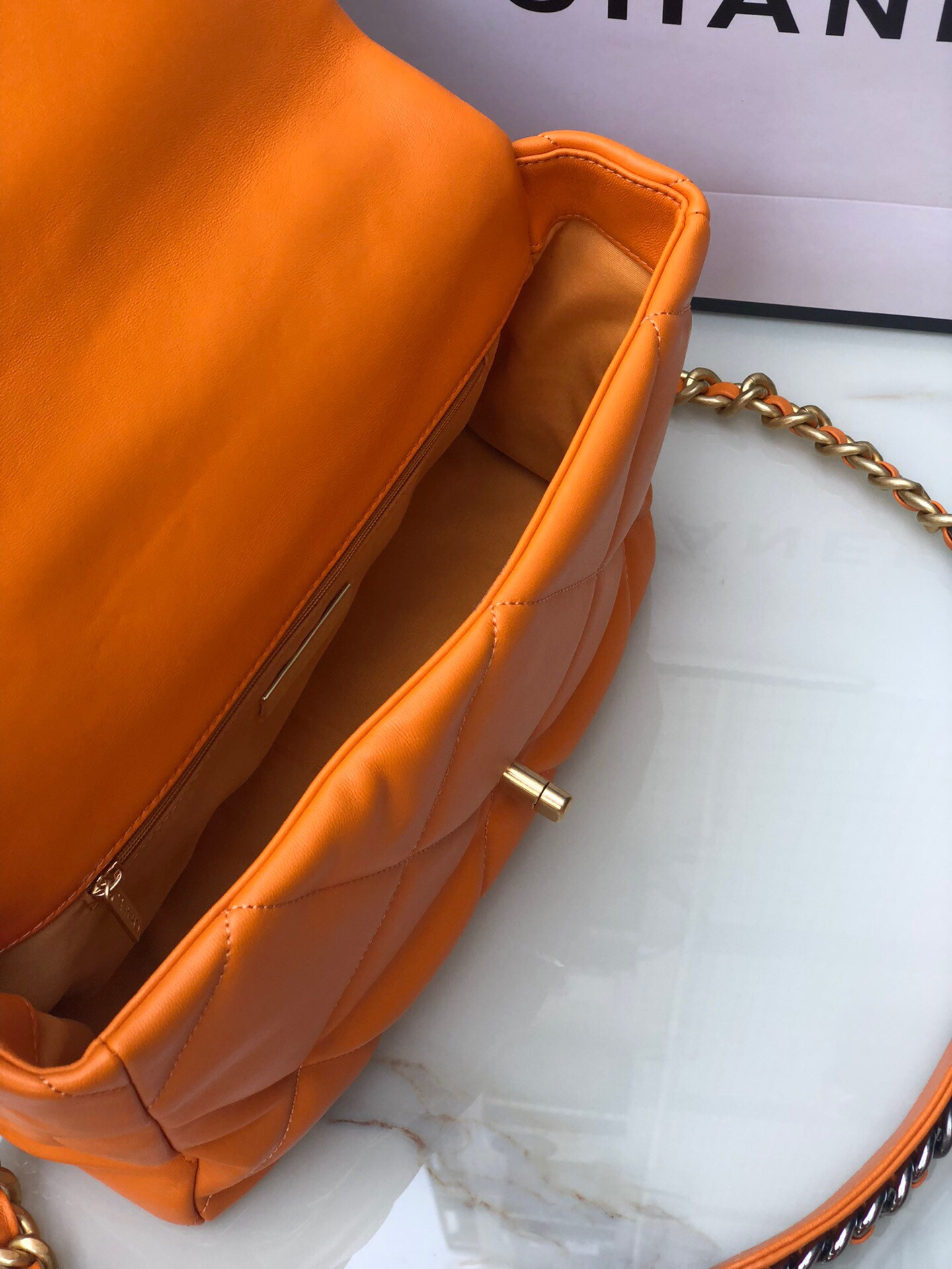 Ch*el 19 large handbag shiny leather, gold-tone, silver-tone & ruthenium-finish metal orange 7.8 × 11.7 × 3.9 in